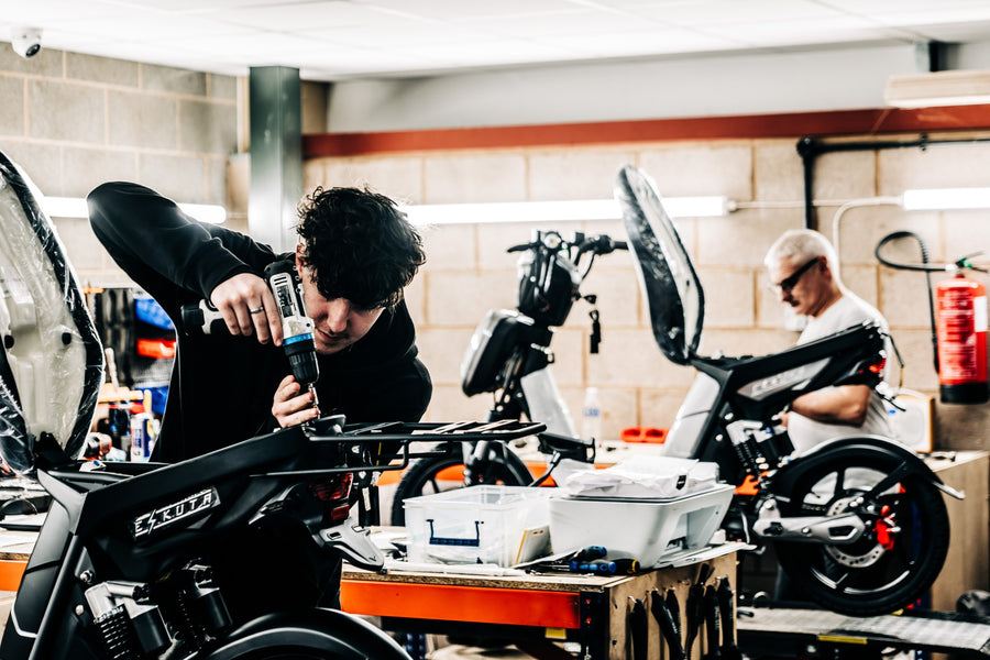 Engineers building E-bikes inside of a warehouse.
