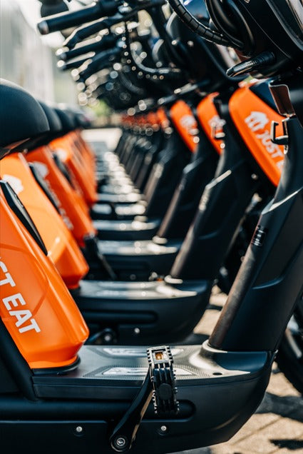 A row of Eskuta SX-250s in orange Just Eat livery