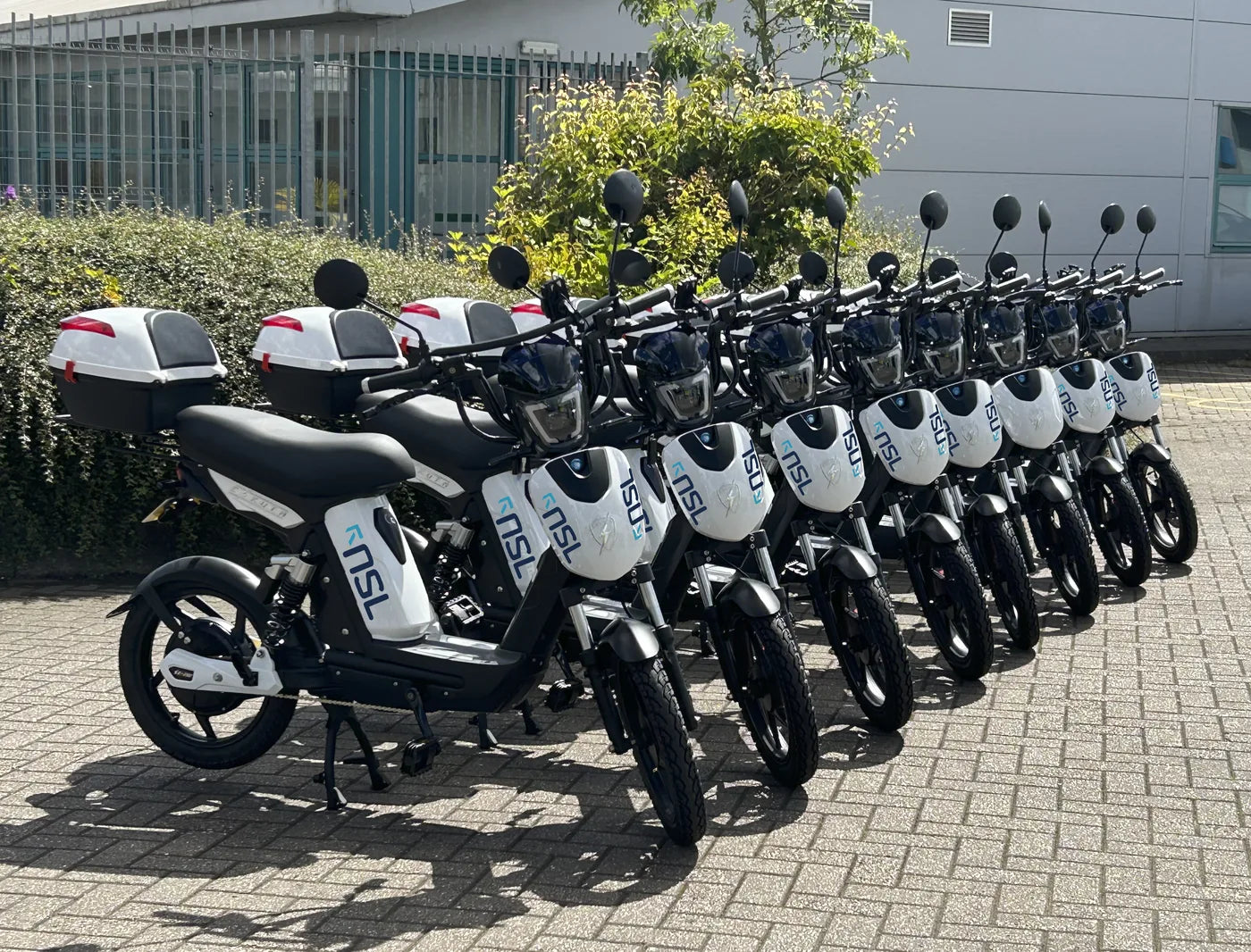 A fleet of Eskuta SX-250s in NSL livery, lined up outside a depot ready for handover